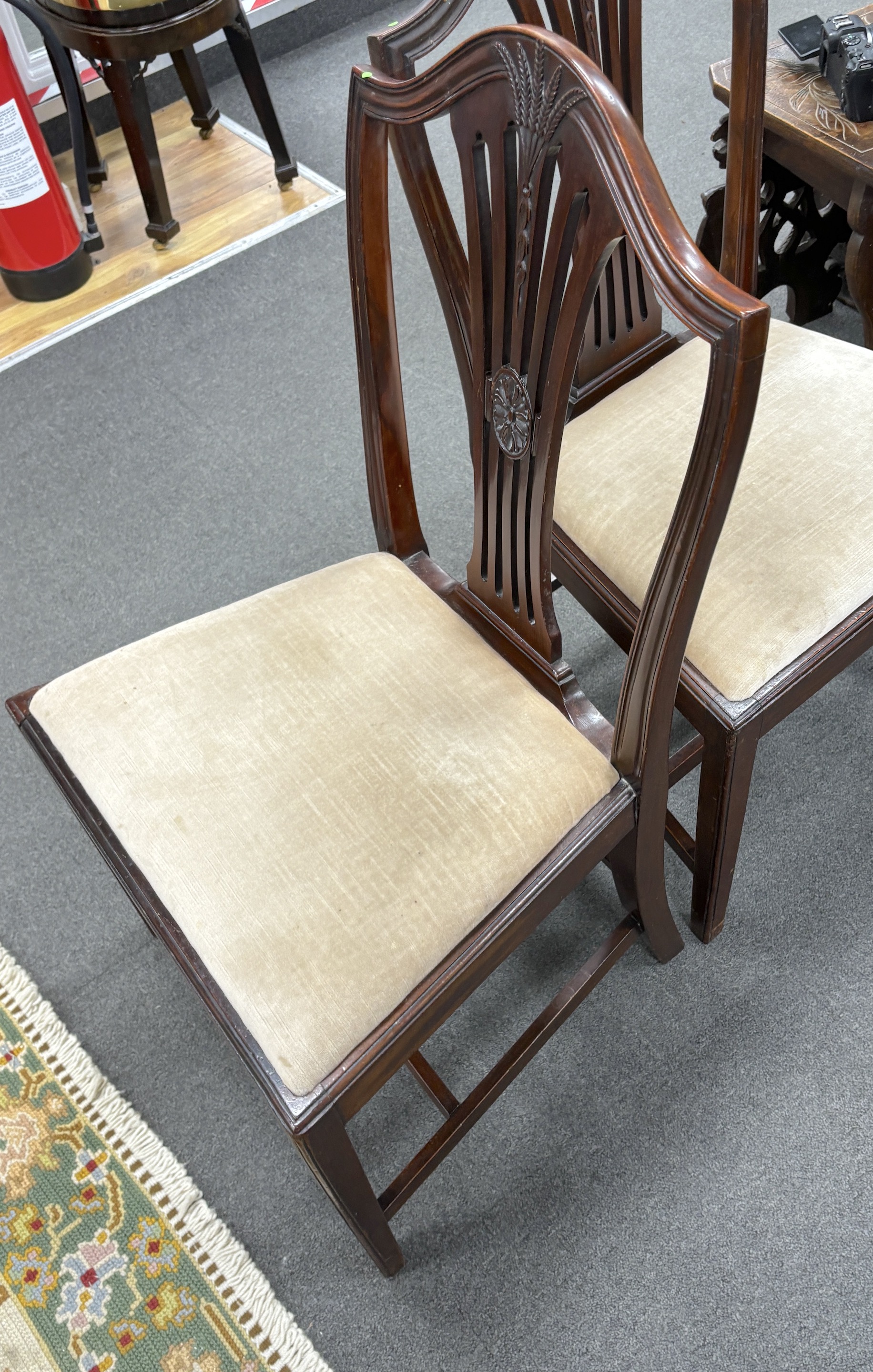 A set of six Hepplewhite style mahogany dining chairs, all singles
